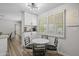 Bright breakfast nook features a round white table with black chairs and white cabinetry and stylish light fixture at 2539 E Geneva Dr, Tempe, AZ 85282