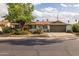 Charming single-story home featuring desert landscaping, a mature shade tree, and a two-car garage at 2539 E Geneva Dr, Tempe, AZ 85282