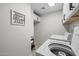 Bright laundry room with appliances, tile floor, and built-in storage at 2539 E Geneva Dr, Tempe, AZ 85282