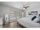 Relaxing main bedroom boasts wood-look floors, a ceiling fan and sliding doors leading to the backyard pool at 2539 E Geneva Dr, Tempe, AZ 85282