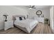 Comfortable main bedroom features a ceiling fan, wood-look floors, dresser, and ample natural light at 2539 E Geneva Dr, Tempe, AZ 85282