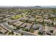 Aerial view showcases a neighborhood with lush landscaping, community parks, and desert mountain views at 2949 E Athena Ave, Gilbert, AZ 85297