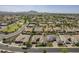 Aerial view of a residential area with lush landscaping, community parks, and mountain views at 2949 E Athena Ave, Gilbert, AZ 85297
