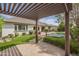 Covered patio view of a lush backyard featuring a pool, manicured landscaping, and flagstone at 2949 E Athena Ave, Gilbert, AZ 85297