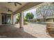 Spacious covered patio with ceiling fans overlooking a pristine pool and green lawn at 2949 E Athena Ave, Gilbert, AZ 85297