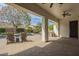 Inviting covered patio with outdoor seating and views of the sparkling pool and lush backyard at 2949 E Athena Ave, Gilbert, AZ 85297