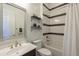 Bright bathroom features a shower-tub combo, modern vanity, and decorative shelving at 2949 E Athena Ave, Gilbert, AZ 85297