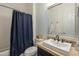 Well-lit bathroom with a vanity sink and a shower with a blue curtain, creating a clean and functional space at 2949 E Athena Ave, Gilbert, AZ 85297