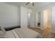 Bright bedroom featuring a ceiling fan, sleek floors, natural light, and convenient ensuite bathroom and closet access at 2949 E Athena Ave, Gilbert, AZ 85297