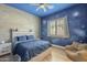 Cozy bedroom with blue space-themed walls, a comfortable bed, and natural light from the window at 2949 E Athena Ave, Gilbert, AZ 85297