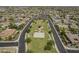 Aerial view of the neighborhood park offering sports court, Gathering play area and lush green space for community activities at 2949 E Athena Ave, Gilbert, AZ 85297