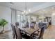 Open dining room featuring modern light fixture, stone accent wall, and wood dining table set at 2949 E Athena Ave, Gilbert, AZ 85297