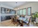 Elegant dining room featuring a chandelier, decorative windows, and custom built-in cabinets at 2949 E Athena Ave, Gilbert, AZ 85297