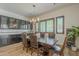 The dining room is adjacent to custom cabinetry with glass doors and display shelves at 2949 E Athena Ave, Gilbert, AZ 85297