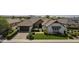Stunning home with manicured lawn, stone accents, a three-car garage, and mature landscaping at 2949 E Athena Ave, Gilbert, AZ 85297