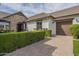 Charming home featuring a stone archway, brick driveway, and manicured hedges at 2949 E Athena Ave, Gilbert, AZ 85297