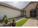 Charming home with a stone archway, outdoor seating, and manicured hedges at 2949 E Athena Ave, Gilbert, AZ 85297
