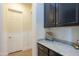 Hallway with granite countertop and cabinetry offers a stylish and functional transition space at 2949 E Athena Ave, Gilbert, AZ 85297