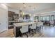 Open kitchen with granite countertops, large island, stainless steel appliances, and modern pendant lights at 2949 E Athena Ave, Gilbert, AZ 85297