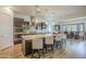 Modern kitchen boasts an island with seating and pendant lighting, and flows into dining area at 2949 E Athena Ave, Gilbert, AZ 85297