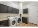 Functional laundry room includes washer, dryer, cabinetry and a folding countertop for convenience at 2949 E Athena Ave, Gilbert, AZ 85297