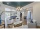 Open-concept living room with stone accent wall, multiple seating areas, and ample natural light at 2949 E Athena Ave, Gilbert, AZ 85297