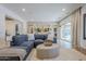 Bright living room with stone accent wall, hardwood floors, and a comfortable blue sectional at 2949 E Athena Ave, Gilbert, AZ 85297