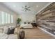The airy main bedroom has a decorative wood wall, hardwood floors and stylish design at 2949 E Athena Ave, Gilbert, AZ 85297