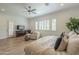 Bright main bedroom with light wood floors, large windows, and sitting area at 2949 E Athena Ave, Gilbert, AZ 85297
