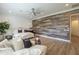 Spacious main bedroom featuring light wood floors, rustic accent wall, and ceiling fan at 2949 E Athena Ave, Gilbert, AZ 85297