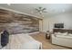 A large main bedroom with wood accent wall, light wood flooring, and sitting area at 2949 E Athena Ave, Gilbert, AZ 85297
