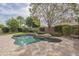 Backyard pool with stone surround, mature trees and privacy landscaping at 2949 E Athena Ave, Gilbert, AZ 85297