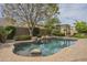 Sparkling backyard pool with rock accents and a pergola in a well-manicured yard at 2949 E Athena Ave, Gilbert, AZ 85297