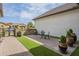 Charming side patio featuring outdoor seating, stone wall and manicured hedges at 2949 E Athena Ave, Gilbert, AZ 85297