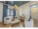 Cozy sitting area with ample natural light, a modern chandelier, and comfortable white chairs at 2949 E Athena Ave, Gilbert, AZ 85297
