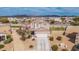 A birds-eye view of the home showcasing the red-tiled roof, landscaping, and mountain views at 30878 W Picadilly Rd, Buckeye, AZ 85396