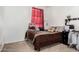 Cozy bedroom featuring window with red curtain, comfortable bed, and dresser at 30878 W Picadilly Rd, Buckeye, AZ 85396