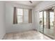 Empty dining room with tiled floors, sliding glass door, and neutral wall colors at 30878 W Picadilly Rd, Buckeye, AZ 85396