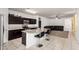 Modern kitchen featuring granite countertops, a breakfast bar, and stainless steel appliances at 30878 W Picadilly Rd, Buckeye, AZ 85396