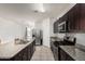 Functional kitchen featuring granite counters, tiled floors and stainless steel appliances at 30878 W Picadilly Rd, Buckeye, AZ 85396