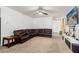 Comfortable living area with a large sectional couch and views of the tiled entryway at 30878 W Picadilly Rd, Buckeye, AZ 85396