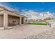 Covered patio featuring a dining set and a built-in grill, ideal for outdoor dining and entertaining guests at 30878 W Picadilly Rd, Buckeye, AZ 85396