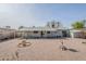 Large backyard with a gravel landscape, covered patio, and potential for customization at 3220 E Andorra Dr, Phoenix, AZ 85032