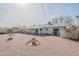 Expansive gravel backyard featuring a covered patio, ideal for low-maintenance outdoor living at 3220 E Andorra Dr, Phoenix, AZ 85032