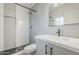 Modern bathroom featuring sleek vanity, gray tile, and walk-in shower at 3220 E Andorra Dr, Phoenix, AZ 85032