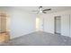 Spacious bedroom with a ceiling fan, closet, and view into the adjoining bathroom at 3220 E Andorra Dr, Phoenix, AZ 85032