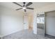 Bedroom featuring mirrored closet, ceiling fan, and access to an adjacent room at 3220 E Andorra Dr, Phoenix, AZ 85032