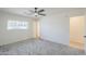 Bedroom featuring ceiling fan, neutral walls, a large window, and access to additional rooms at 3220 E Andorra Dr, Phoenix, AZ 85032
