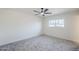 Bright bedroom featuring a ceiling fan, neutral walls, a large window, and carpet flooring at 3220 E Andorra Dr, Phoenix, AZ 85032