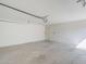 Well-lit garage with smooth concrete floors and white-painted walls for a clean, organized space at 3220 E Andorra Dr, Phoenix, AZ 85032